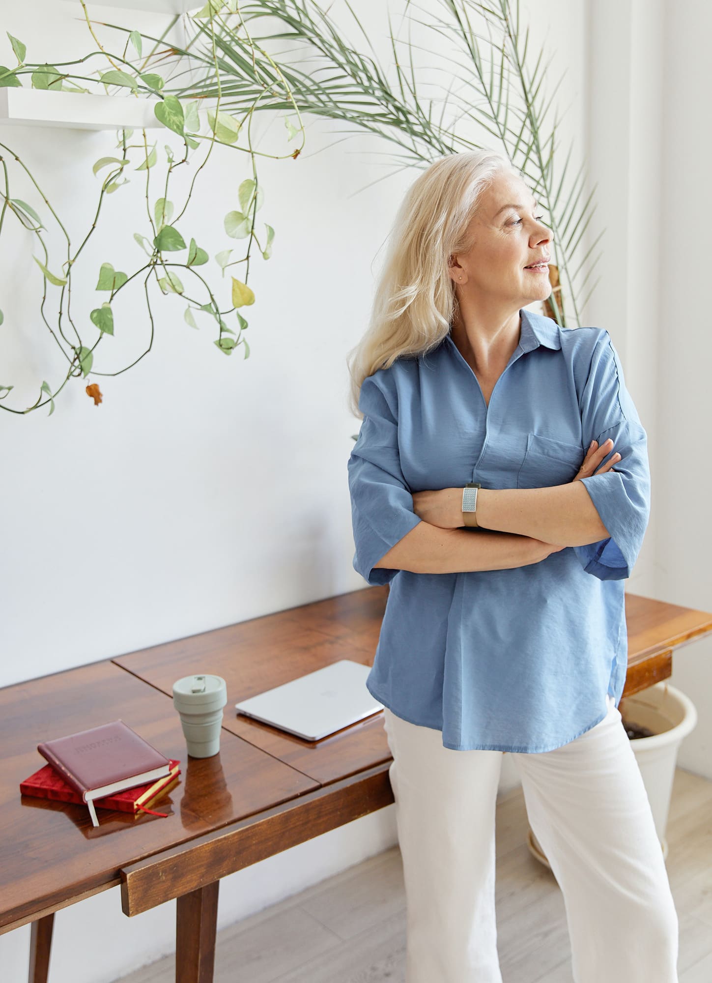 Woman with arms crossed looking sideways