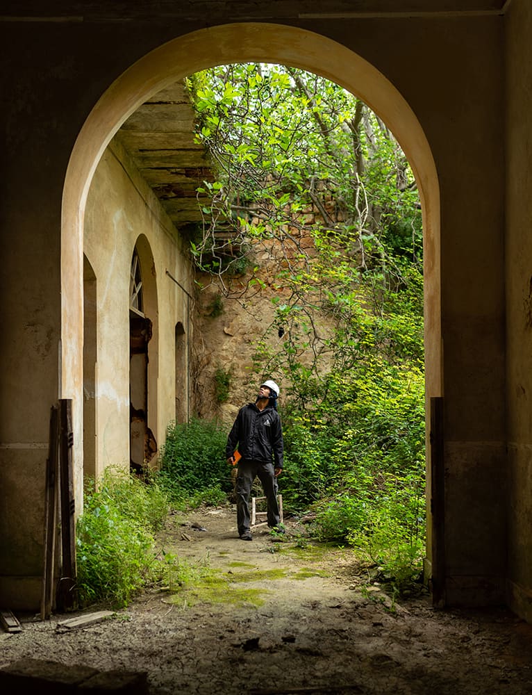 Man in black jacket and black pants walking on pathway
